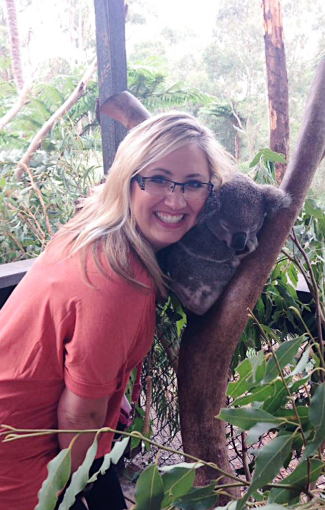 Julie Smothers cheek-to-cheek with a koala bear.